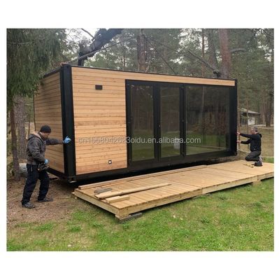 Entrepôt métallique en bois miniature personnalisé Conteneur modernement évolutif Maison préfabriquée pour panneau de sandwich en acier extérieur
